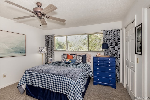 bedroom featuring light carpet, a textured ceiling, a closet, and ceiling fan