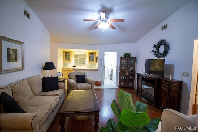 living room featuring ceiling fan and dark hardwood / wood-style floors