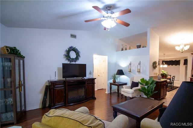 living room with vaulted ceiling, ceiling fan with notable chandelier, and hardwood / wood-style floors