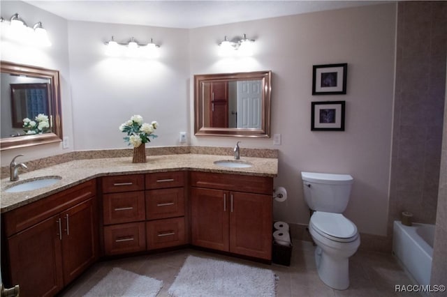 bathroom with toilet, vanity, and tile patterned flooring