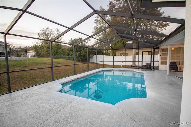 view of pool with a lanai, a patio area, and a yard