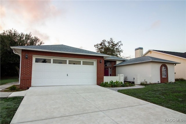 view of front of house featuring a lawn and a garage