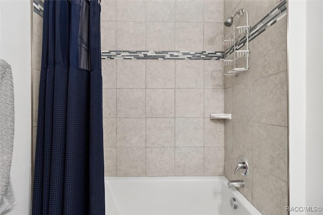 bathroom with shower / bath combo with shower curtain