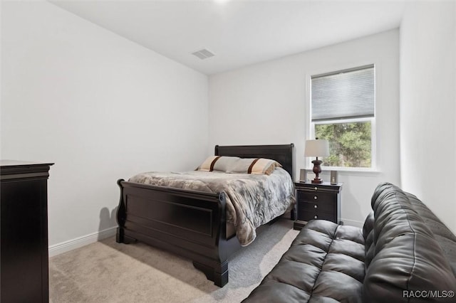 bedroom featuring light carpet