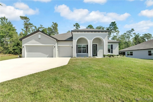 mediterranean / spanish-style home with a garage and a front yard