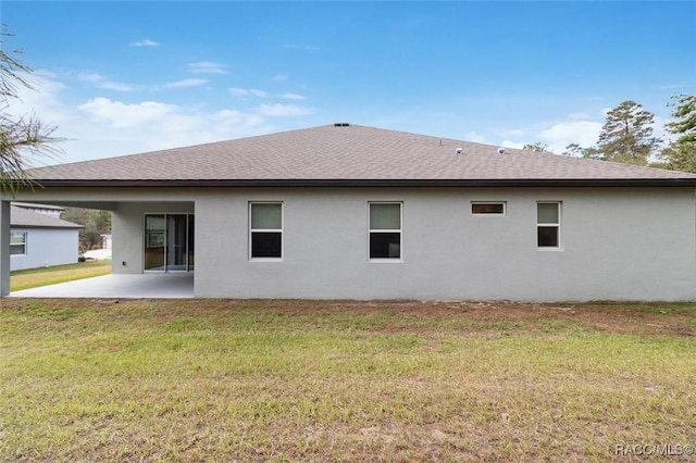 back of property featuring a lawn and a patio area