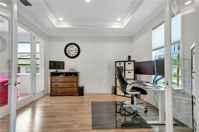 office space featuring french doors, a raised ceiling, and a wealth of natural light