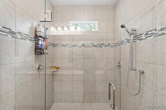 bathroom with a shower with shower door