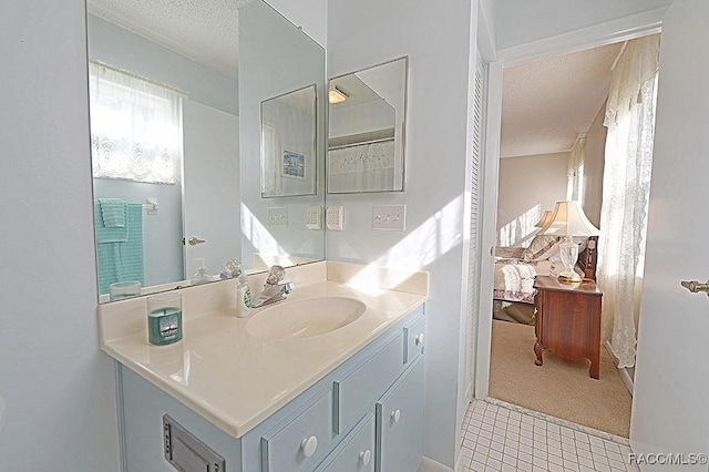 bathroom featuring tile patterned flooring, a textured ceiling, and vanity