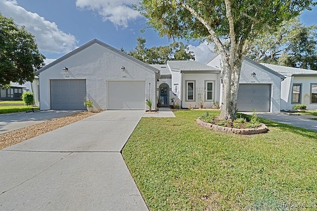 single story home with a front yard and a garage