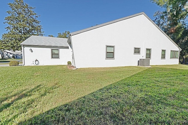 back of house featuring cooling unit and a yard