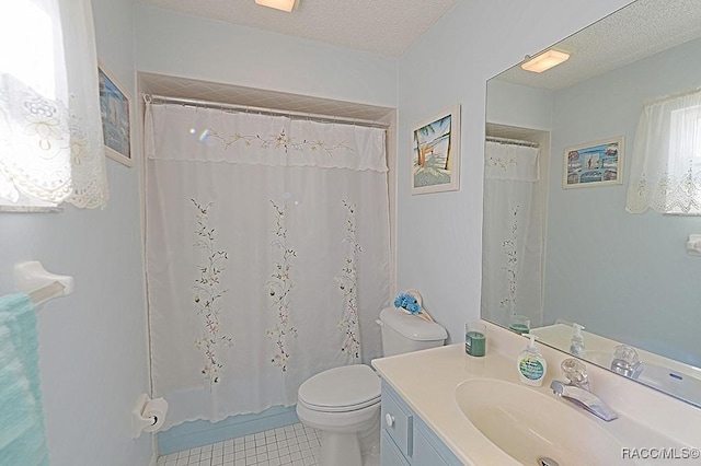 bathroom featuring tile patterned flooring, vanity, a textured ceiling, and toilet