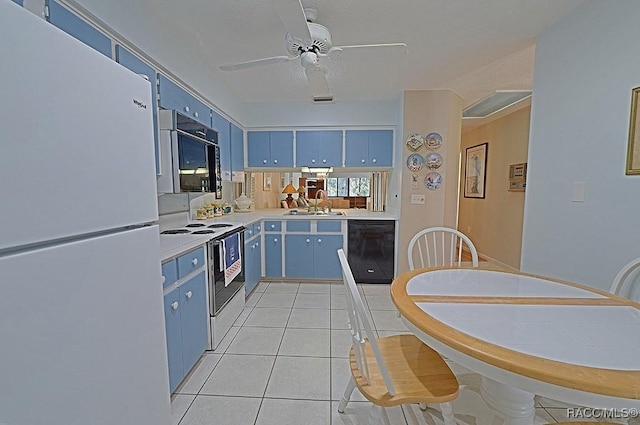 kitchen featuring light tile patterned flooring, white refrigerator, blue cabinets, black dishwasher, and electric range oven