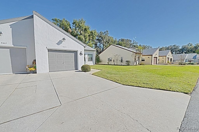 view of front of home featuring a garage and a front lawn