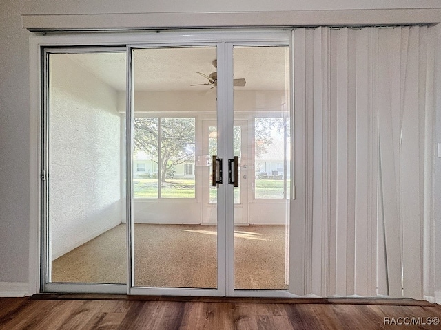 doorway to outside featuring hardwood / wood-style floors, ceiling fan, and french doors