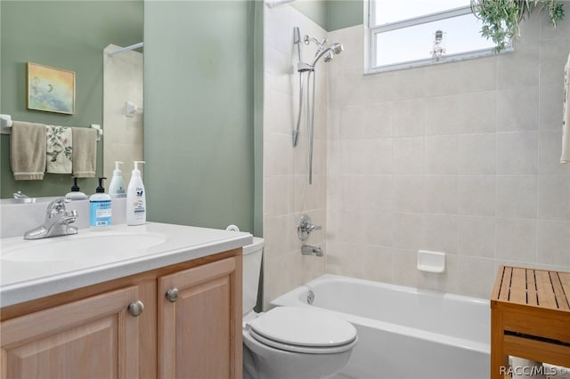 full bathroom with vanity, toilet, and tiled shower / bath