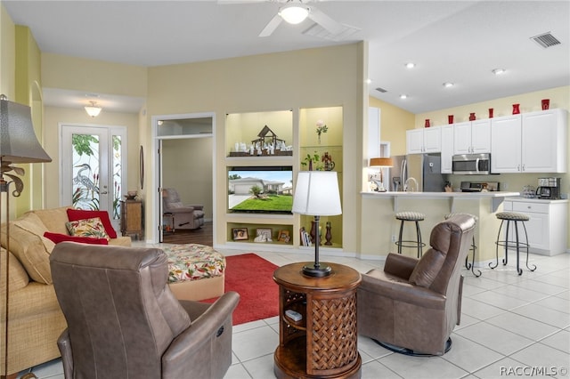 living room featuring light tile patterned floors and ceiling fan