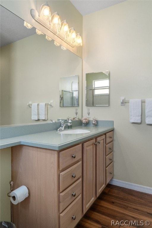 bathroom with hardwood / wood-style floors and vanity