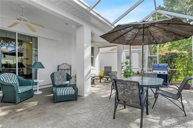 view of patio featuring glass enclosure and ceiling fan