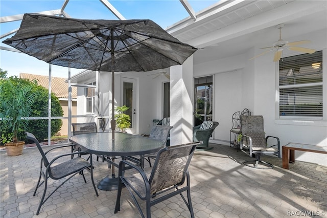 view of patio / terrace featuring ceiling fan and a lanai