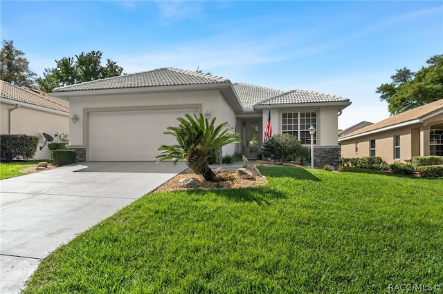 mediterranean / spanish home with a front yard and a garage