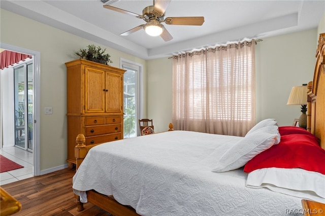 bedroom featuring access to outside, ceiling fan, and dark wood-type flooring