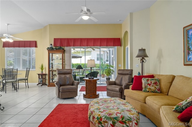 tiled living room with ceiling fan and vaulted ceiling