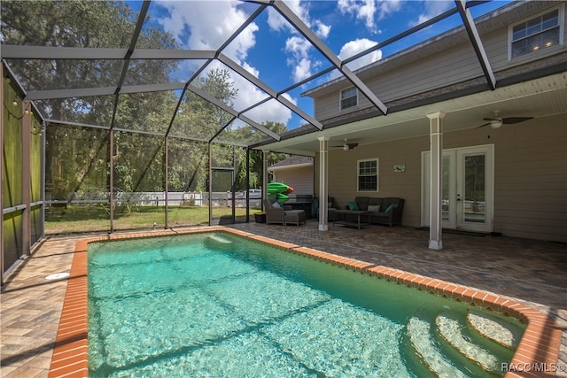 view of swimming pool with a lanai, a patio area, ceiling fan, and an outdoor living space