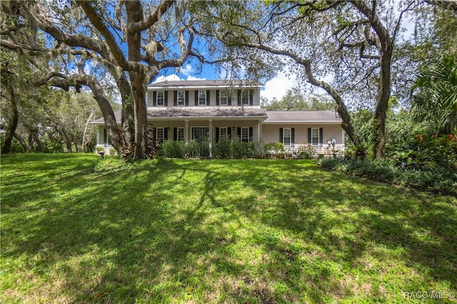 rear view of property with a lawn