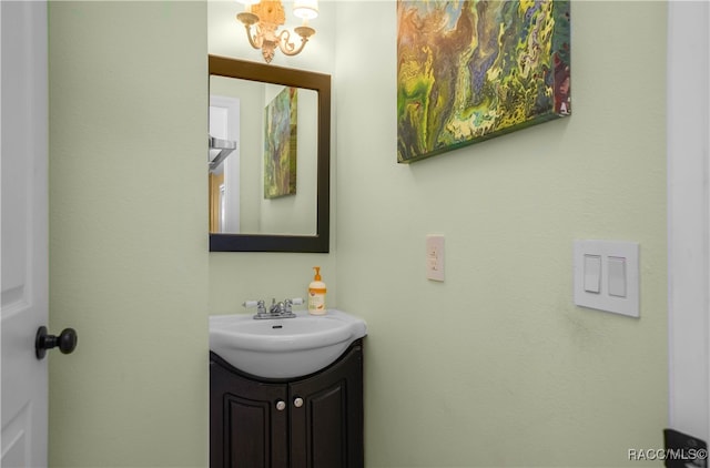 bathroom featuring vanity and a notable chandelier