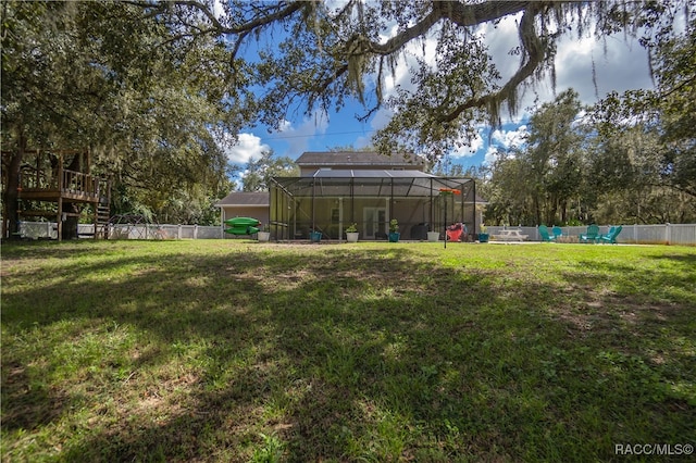 view of yard featuring glass enclosure