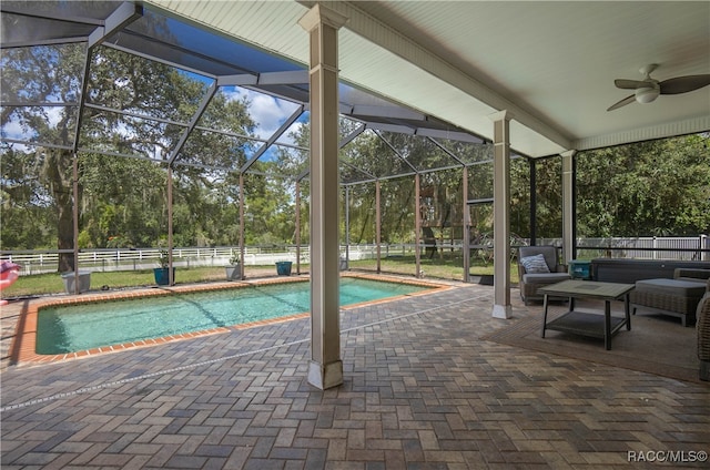 view of pool featuring a lanai, ceiling fan, and a patio