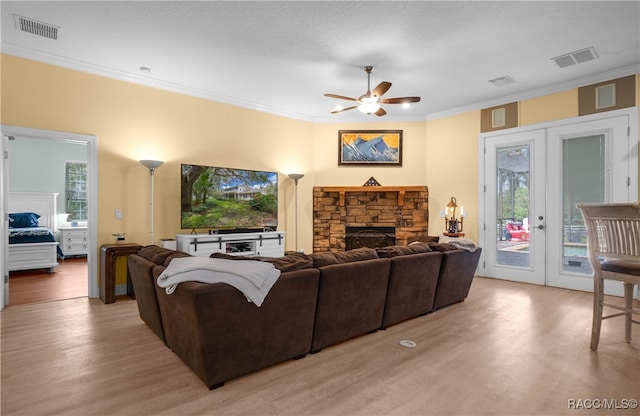 living room with ceiling fan, french doors, crown molding, and light hardwood / wood-style flooring