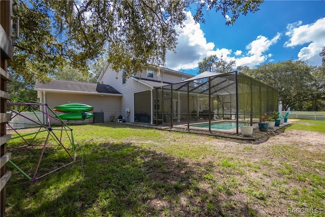 back of house featuring a lanai and central air condition unit