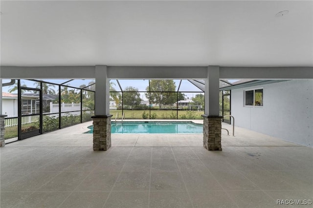 view of pool with a patio area and glass enclosure