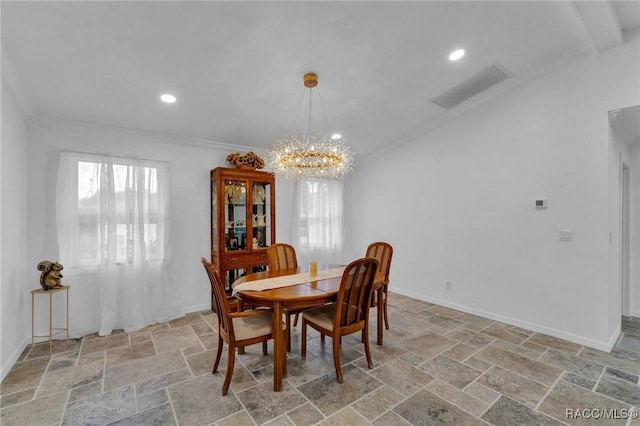 dining area featuring crown molding and an inviting chandelier