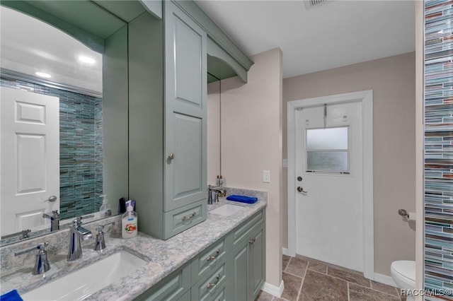 bathroom featuring toilet and vanity