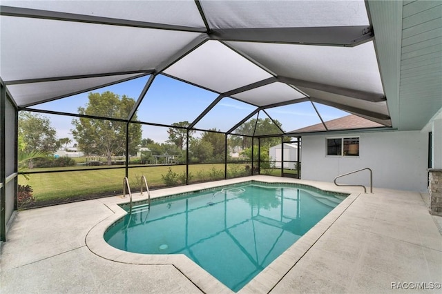 view of swimming pool with a lanai, a patio area, a storage unit, and a lawn