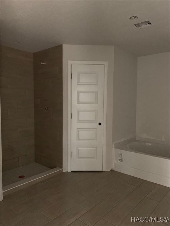 bathroom featuring plus walk in shower