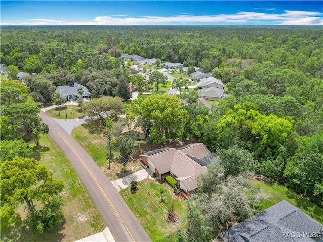 bird's eye view with a wooded view