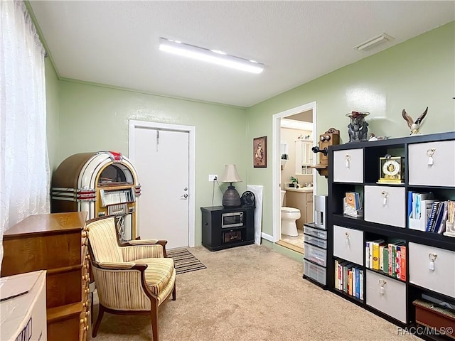 sitting room with carpet and visible vents