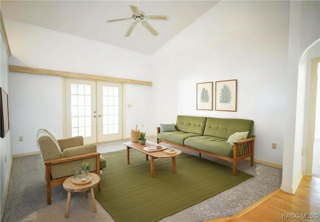 living area with french doors, high vaulted ceiling, arched walkways, a ceiling fan, and wood finished floors