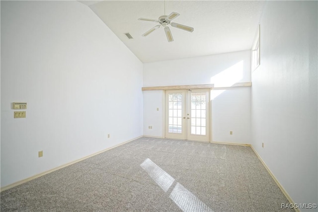 spare room with french doors, lofted ceiling, visible vents, ceiling fan, and carpet
