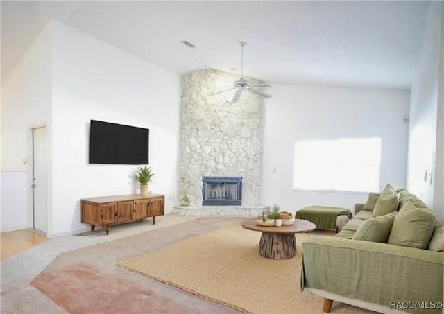 living area with a fireplace, high vaulted ceiling, visible vents, and ceiling fan