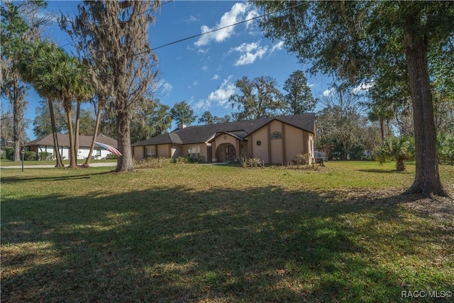 view of front of property featuring a front yard and stucco siding