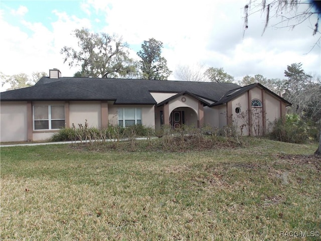 ranch-style home featuring a front yard