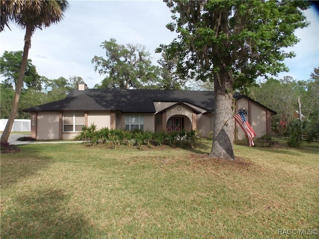 single story home with a front lawn and stucco siding