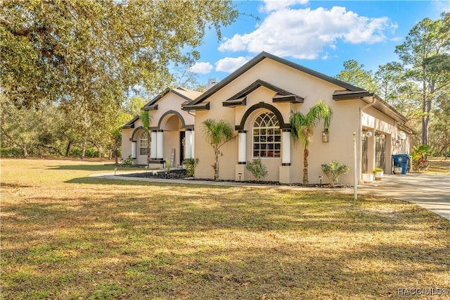 view of front of house with a front yard and a garage