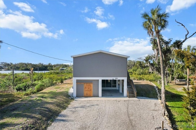 garage with a water view and driveway