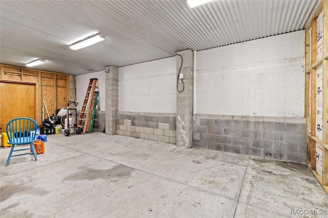 garage with concrete block wall